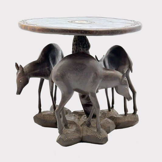 unique table features intricate details of an African face and deer