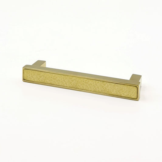 Brass hammered face cabinet pull on a white background