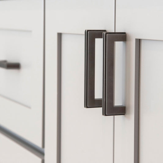 The Carrara Square cabinet pull mounted on shaker style cabinet doors