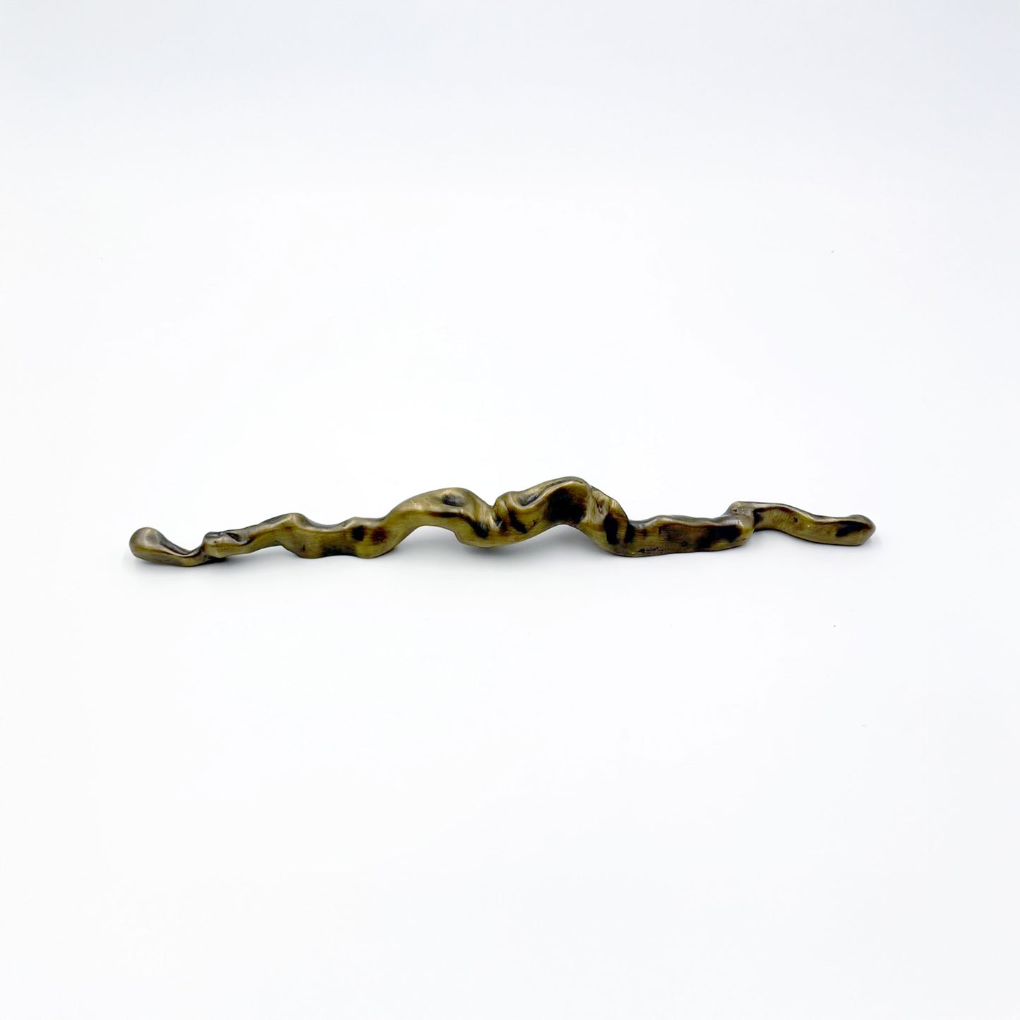 an abstract, wavy metal cabinet handle from the side with a distressed bronze finish, displayed vertically on a plain white background.