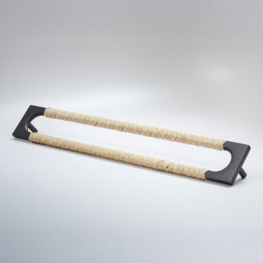 A modern long rectangular cabinet pull handle with a dark oil-rubbed bronze metal frame with an oval shaped-cutout and a light tan leather woven grip, shown on a white background.