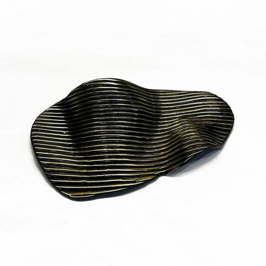 a incised organic shaped cup pull in a dark antique brass finish on a white background