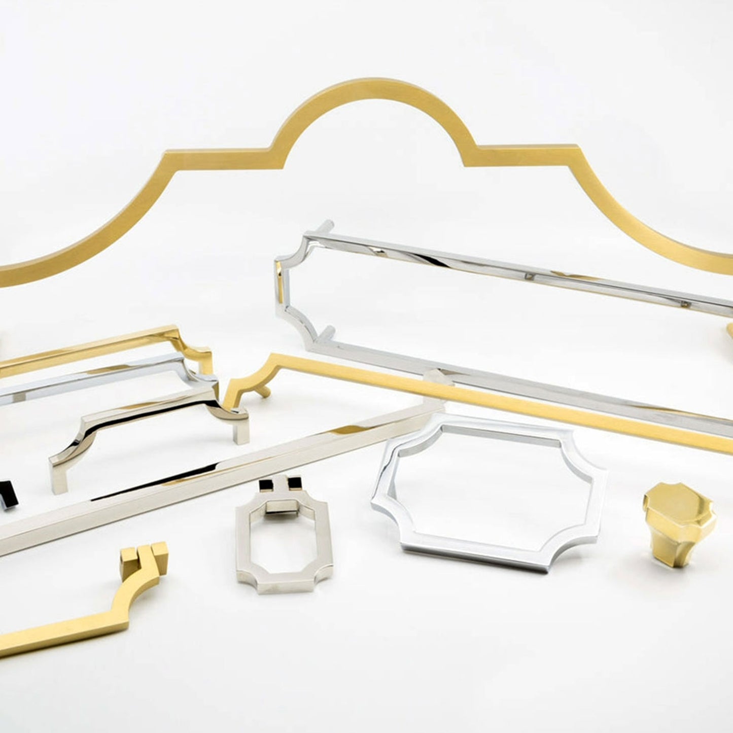 A collection of modern cabinet hardware and drawer pulls in polished gold and silver finishes, arranged on a clean white background.