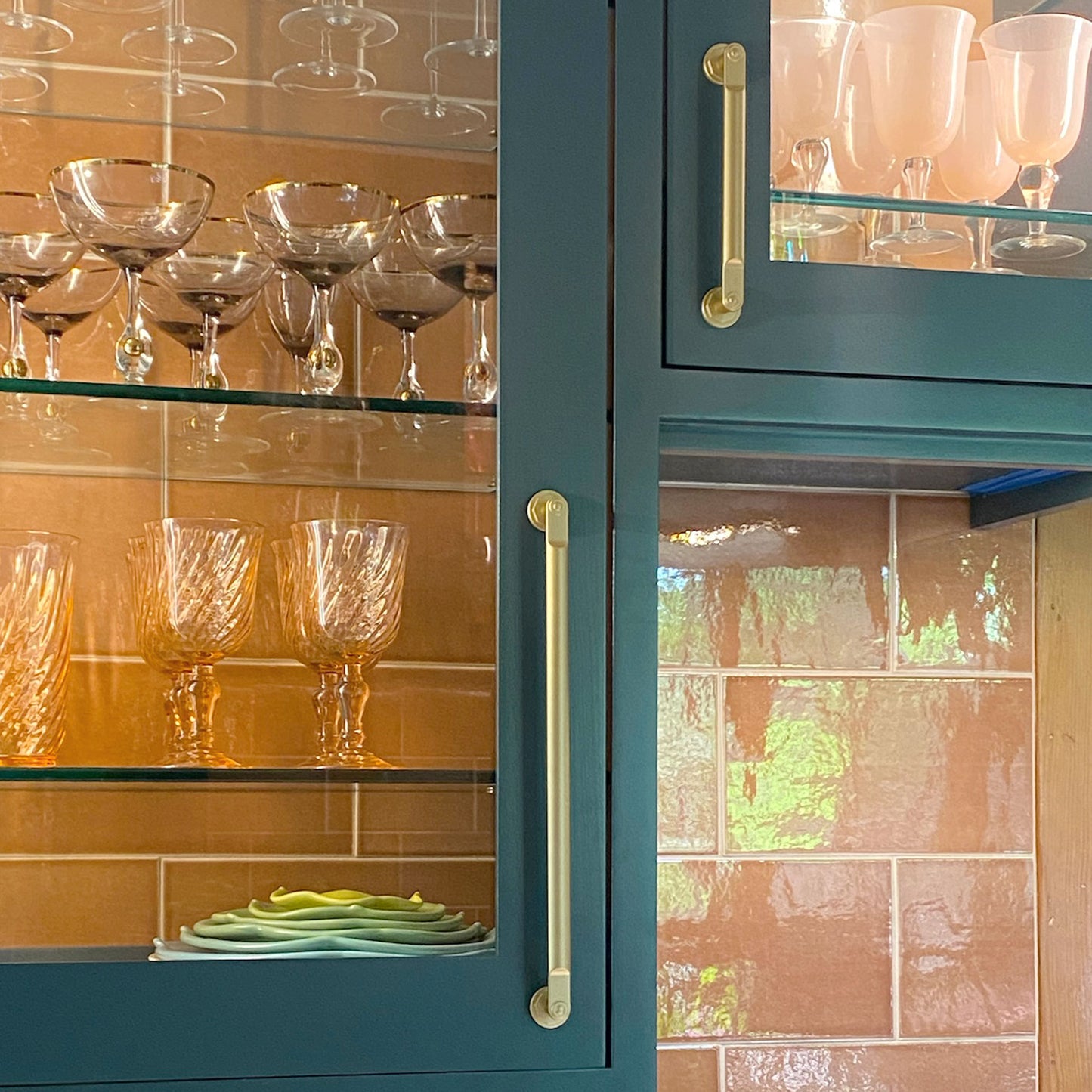 Industrial Modern cabinet pulls in satin brass installed on colorful cabinet doors