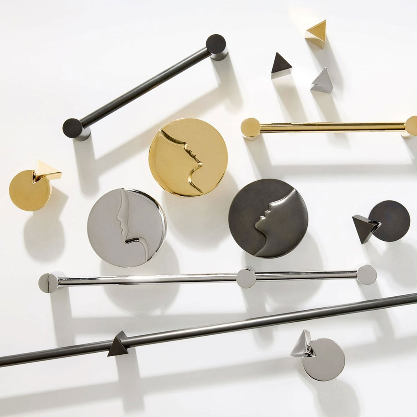 A collection of modern metal cabinet knob and handles in polished gold, matte black, and brushed silver, arranged on a clean white background.