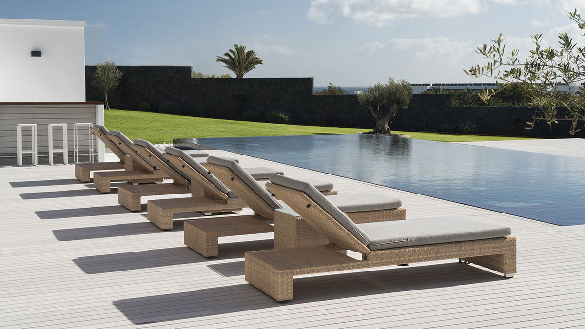 Six contemporary loungers surrounding an infinity pool atop Esthec modern decking.