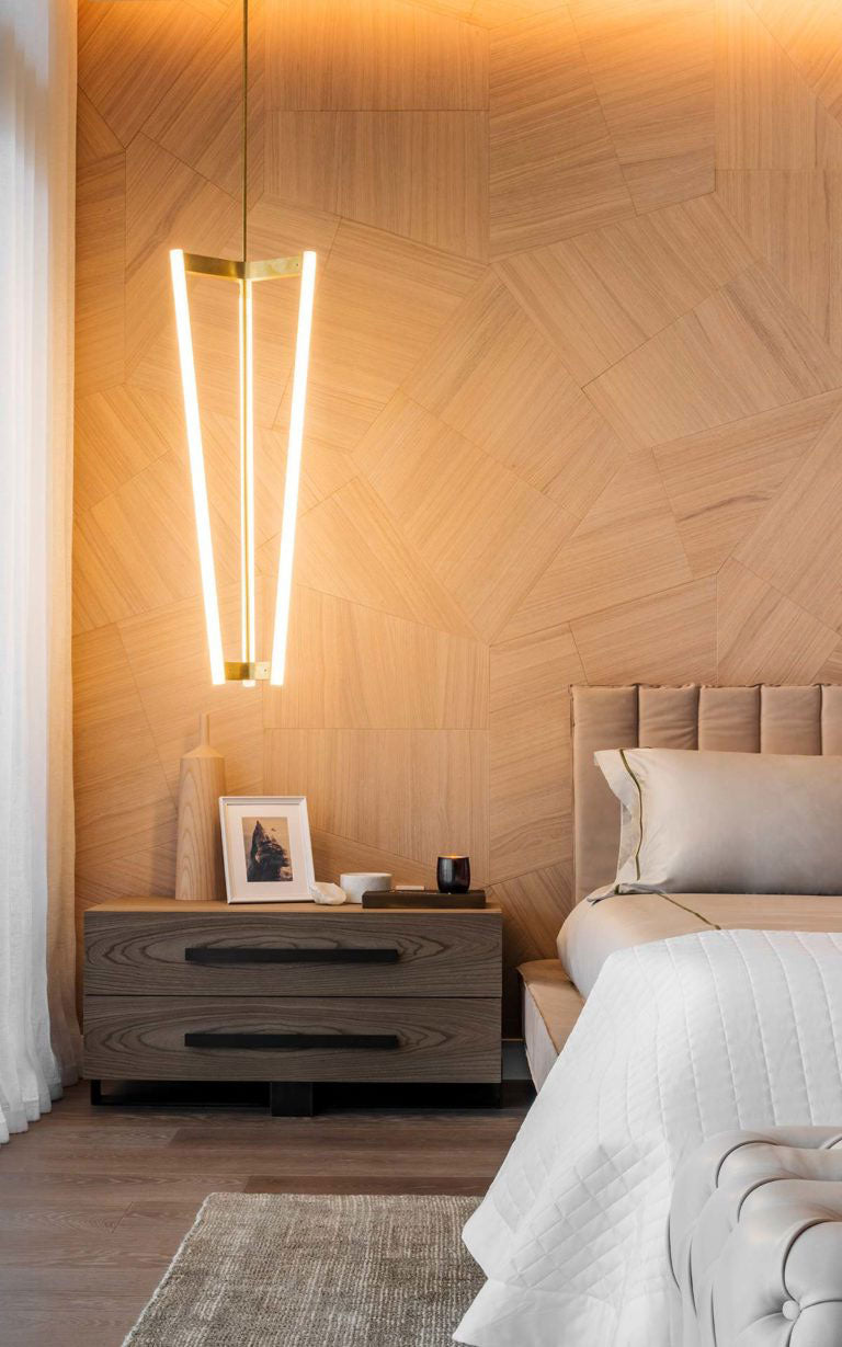A contemporary hanging bedside sconce hanging in front of Natural Genius Slide wood cladding.