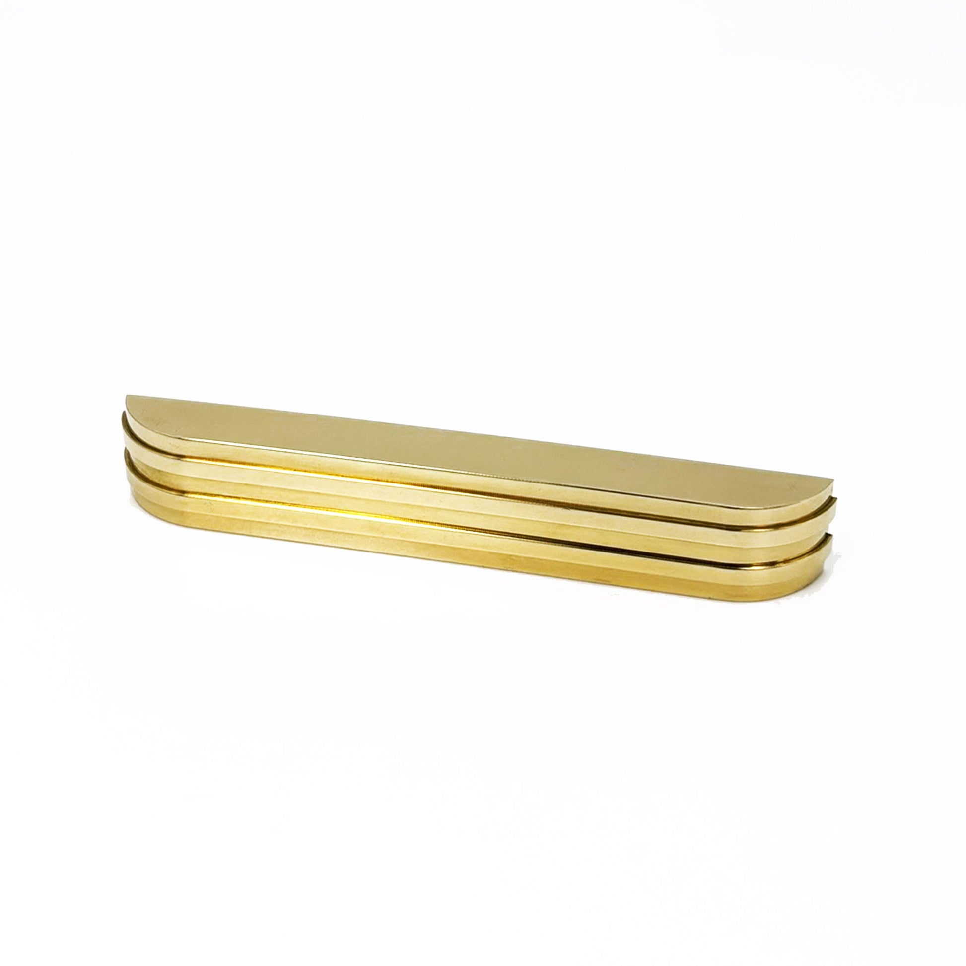 a ribbed brass metal bar cup pull on a white background