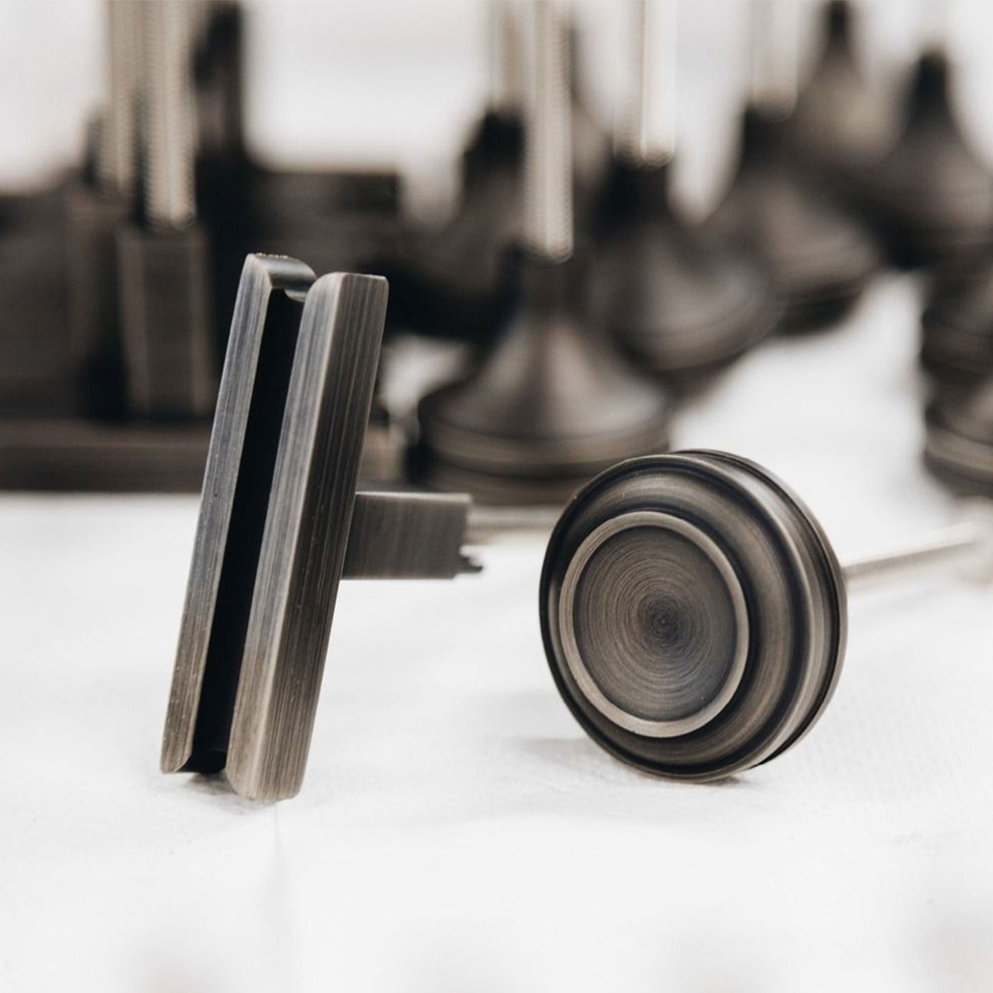 Close-up view of a ribbed Granby knob and T-Pull with blurred background and white countertop