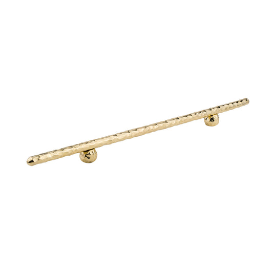 Brass hand-hammered cabinet handle on a white background