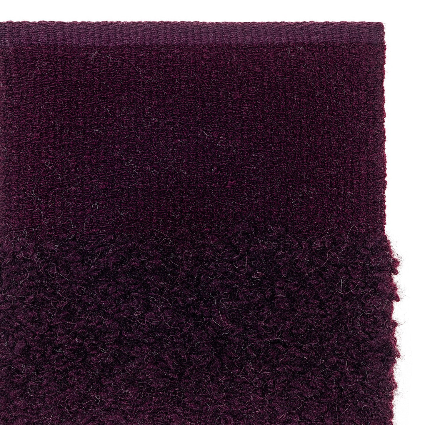 prado rug style in claret colored woven boucle and flat weave