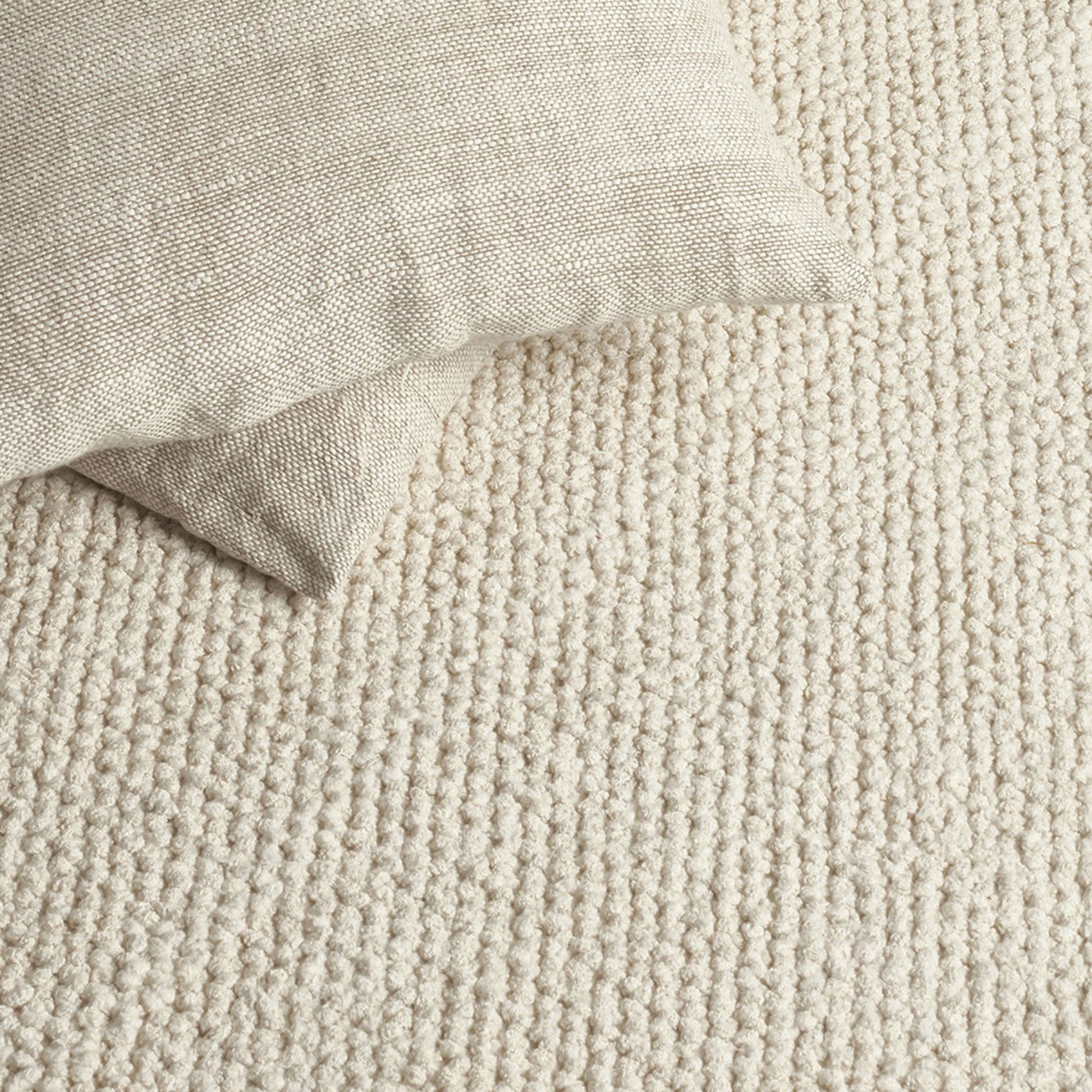 Nui rug style in Cream colored textured twill boucle weave with linen pillows