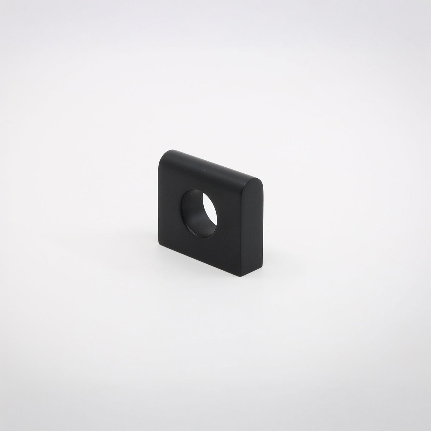 A small square metallic hardware piece with rounded corners and a circular hole, shown on a clean light gray background.