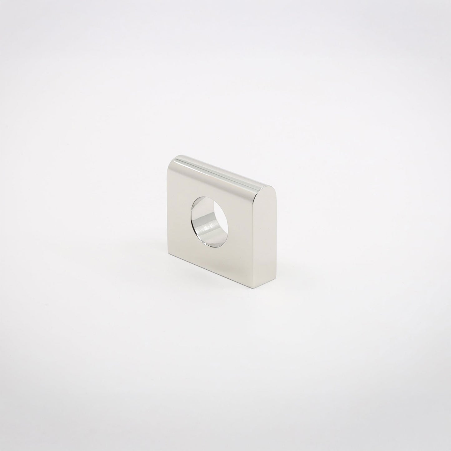 A small square metallic hardware piece with rounded corners and a circular hole, shown on a clean light gray background.