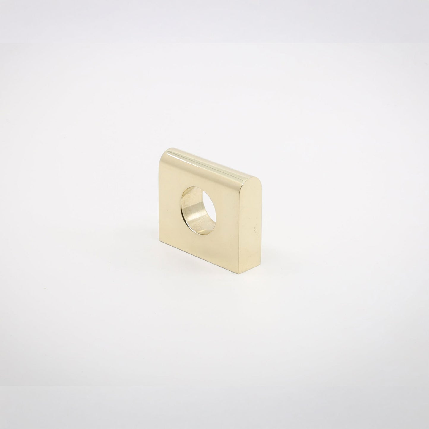A small square metallic hardware piece with rounded corners and a circular hole, shown on a clean light gray background.