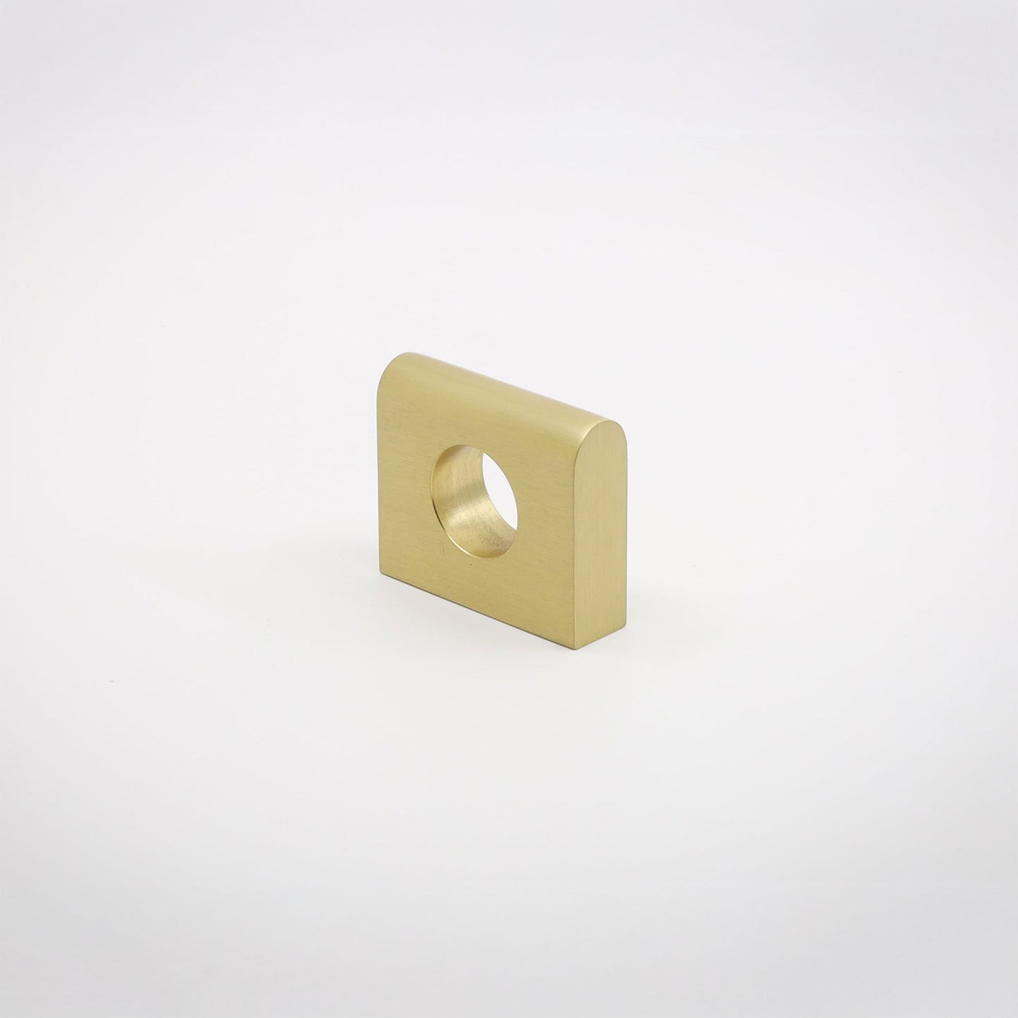 A small square metallic hardware piece with rounded corners and a circular hole, shown on a clean light gray background.