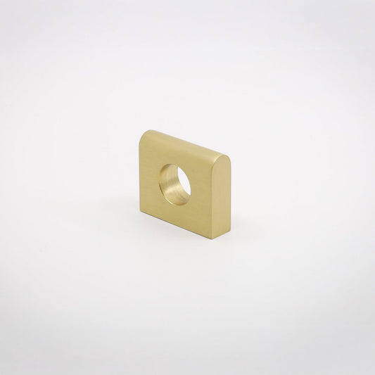 A small square metallic hardware piece with rounded corners and a circular hole, shown on a clean light gray background.