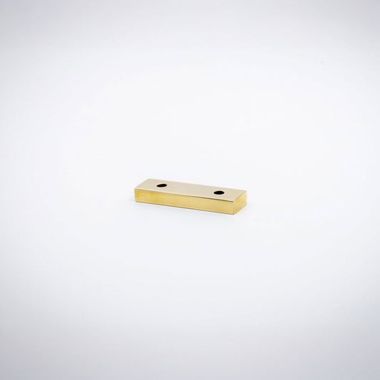 A small rectangular polished brass hardware piece with two pre-drilled holes, shown on a plain white background.