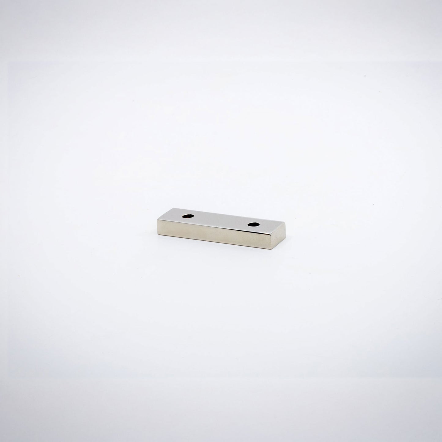 A small rectangular polished nickel hardware piece with two pre-drilled holes, shown on a plain white background.