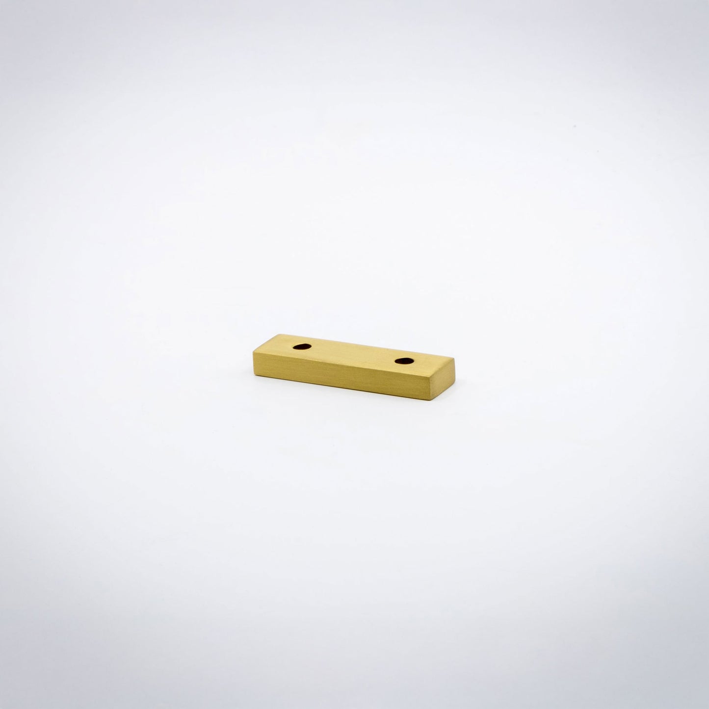 A small rectangular polished brass hardware piece with two pre-drilled holes, shown on a plain white background.