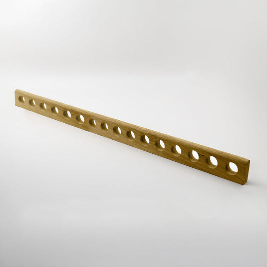 A long, narrow wooden handle with multiple evenly spaced circular holes, shown diagonally on a light gray studio background.
