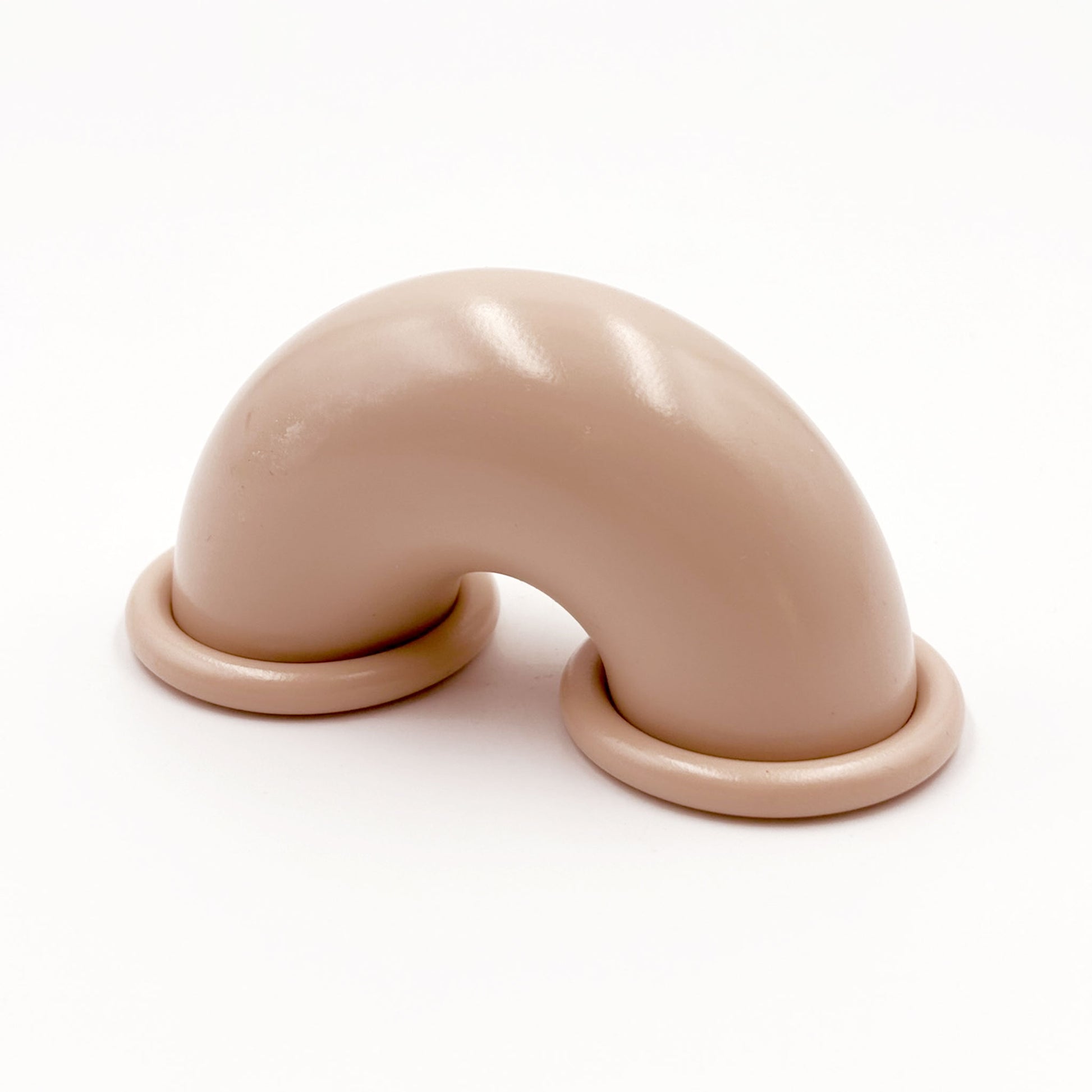 Beige colored macaroni-shaped handles on a white background