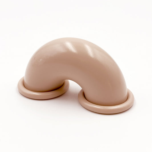 Beige colored macaroni-shaped handles on a white background