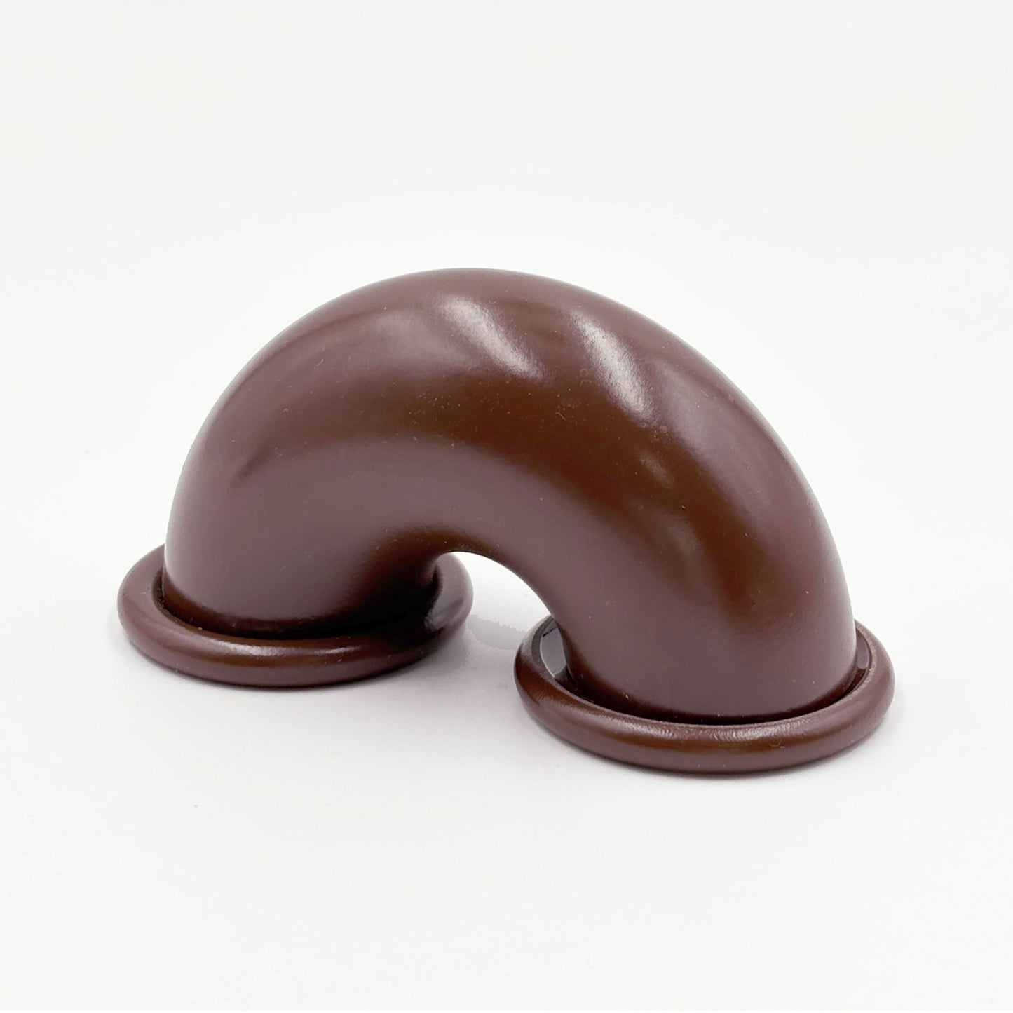 Brown colored macaroni-shaped handles on a white background