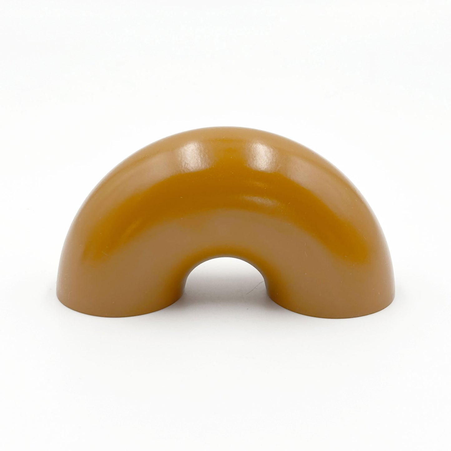 caramel colored macaroni-shaped handles on a white background