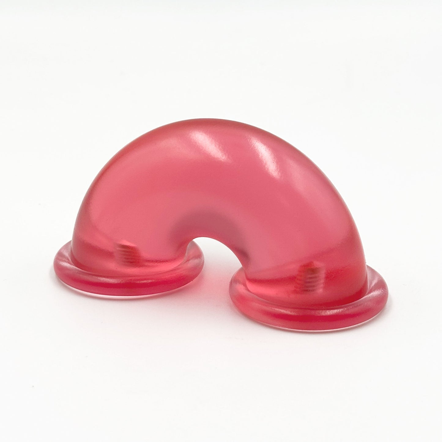 Translucent red colored macaroni-shaped handles on a white background