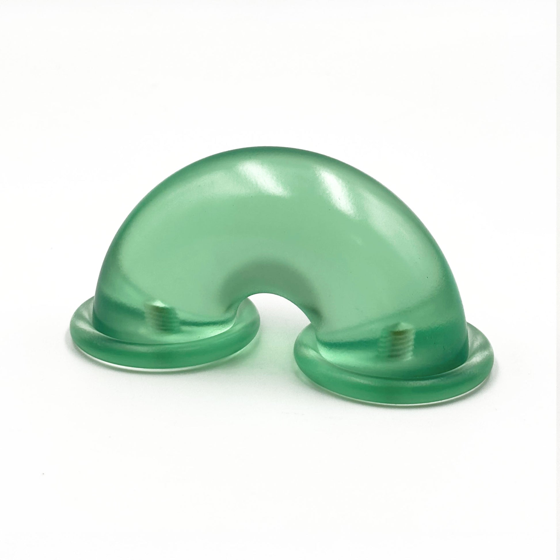 Translucent green colored macaroni-shaped handles on a white background