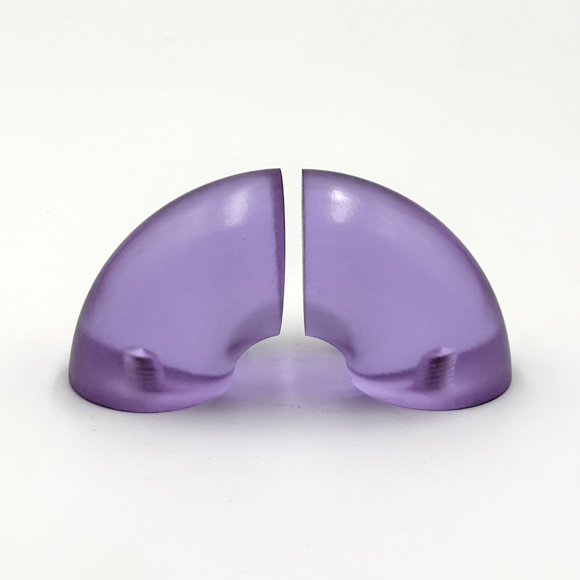 Translucent purple colored macaroni-half shaped handles on a white 