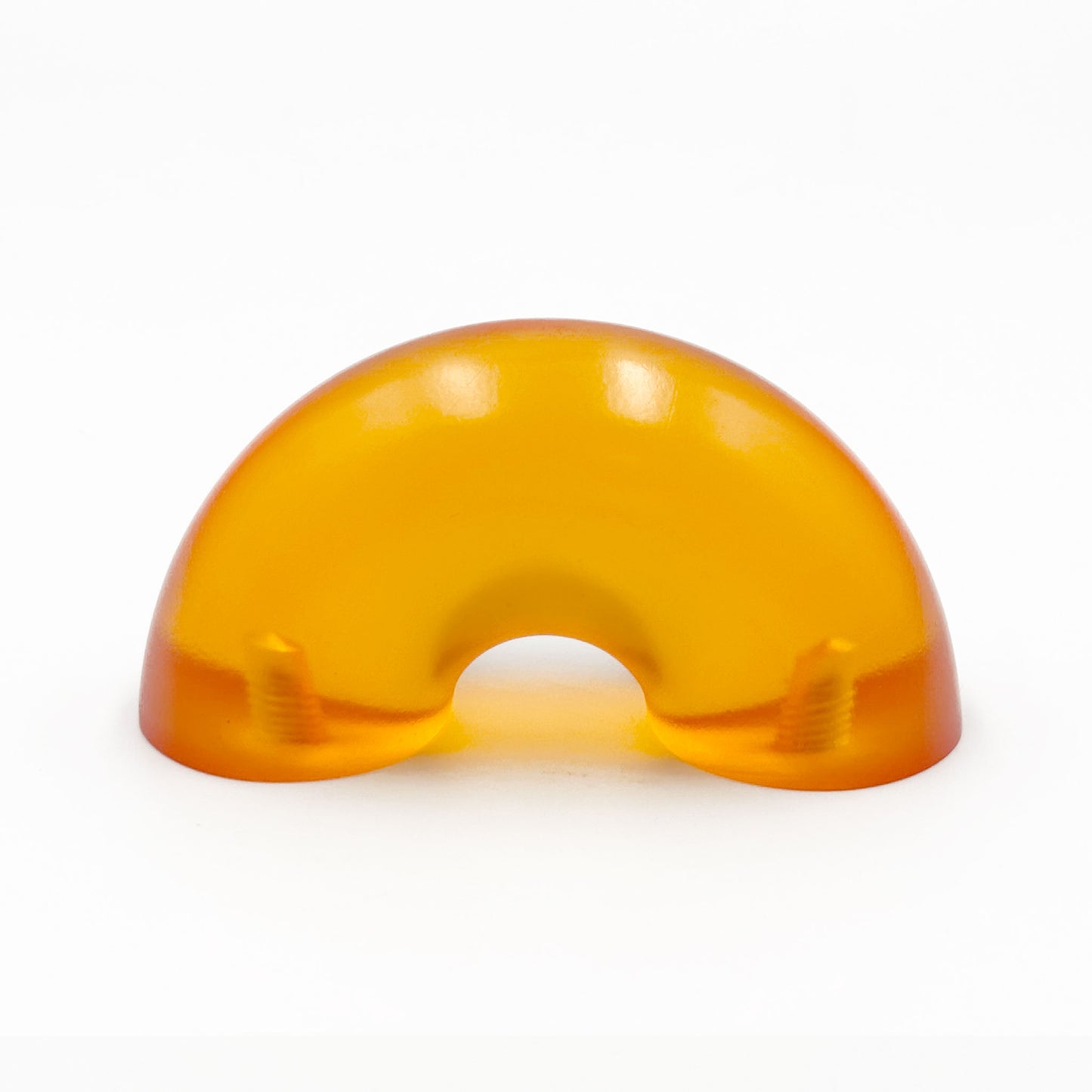 Translucent orange colored macaroni-shaped handles on a white background