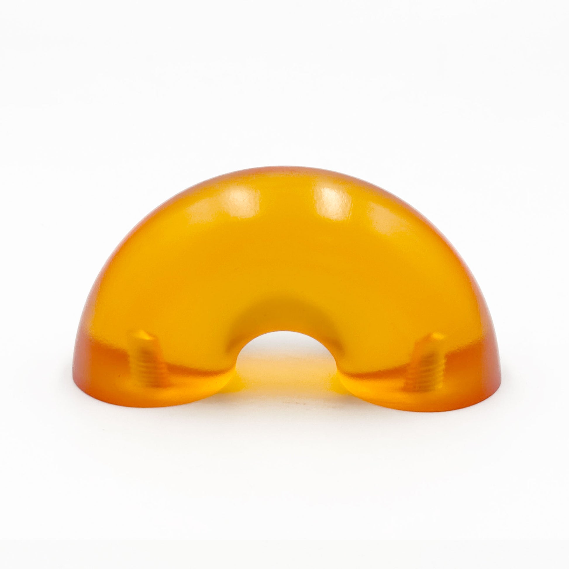 Translucent orange colored macaroni-shaped handles on a white background