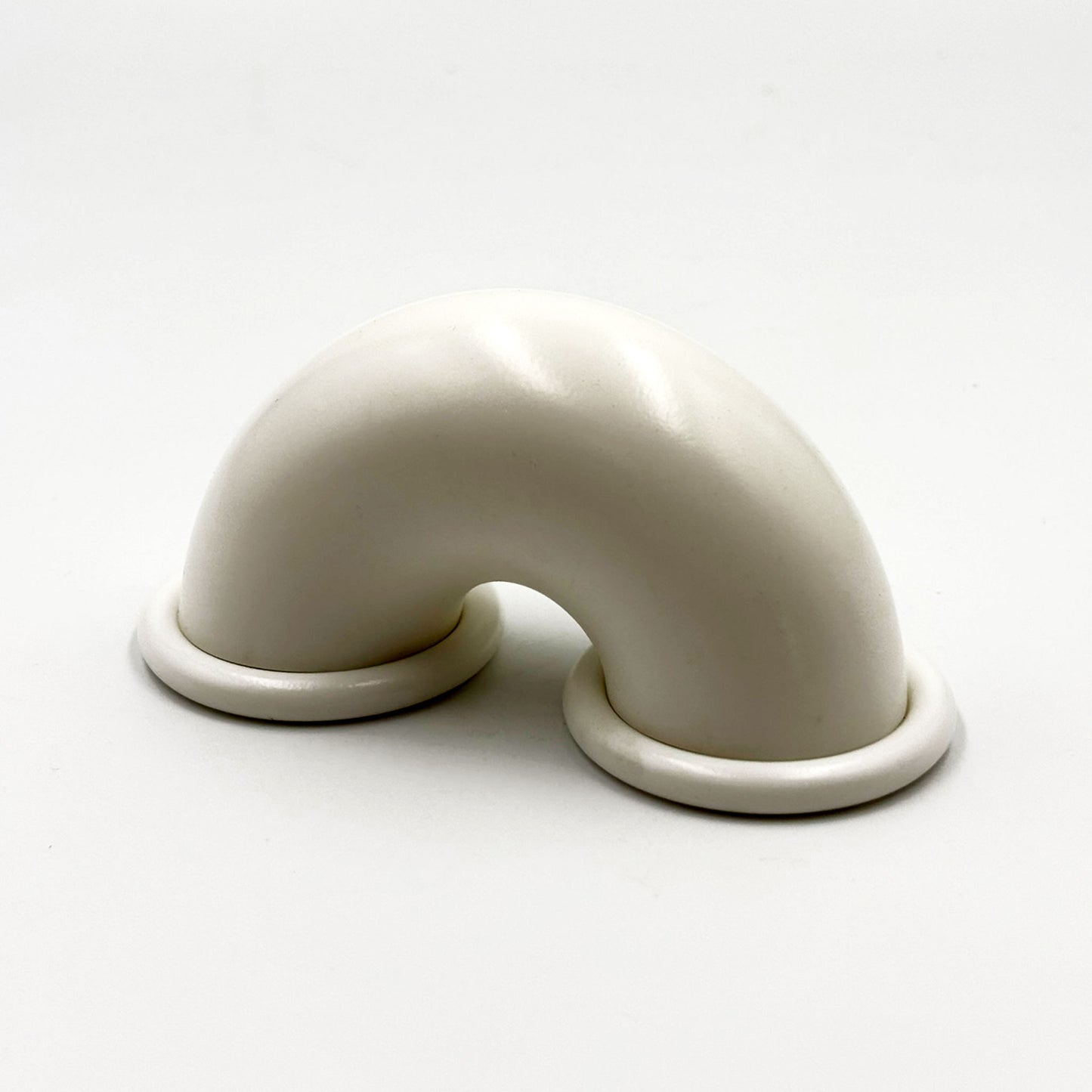 White colored macaroni-shaped handles on a white background