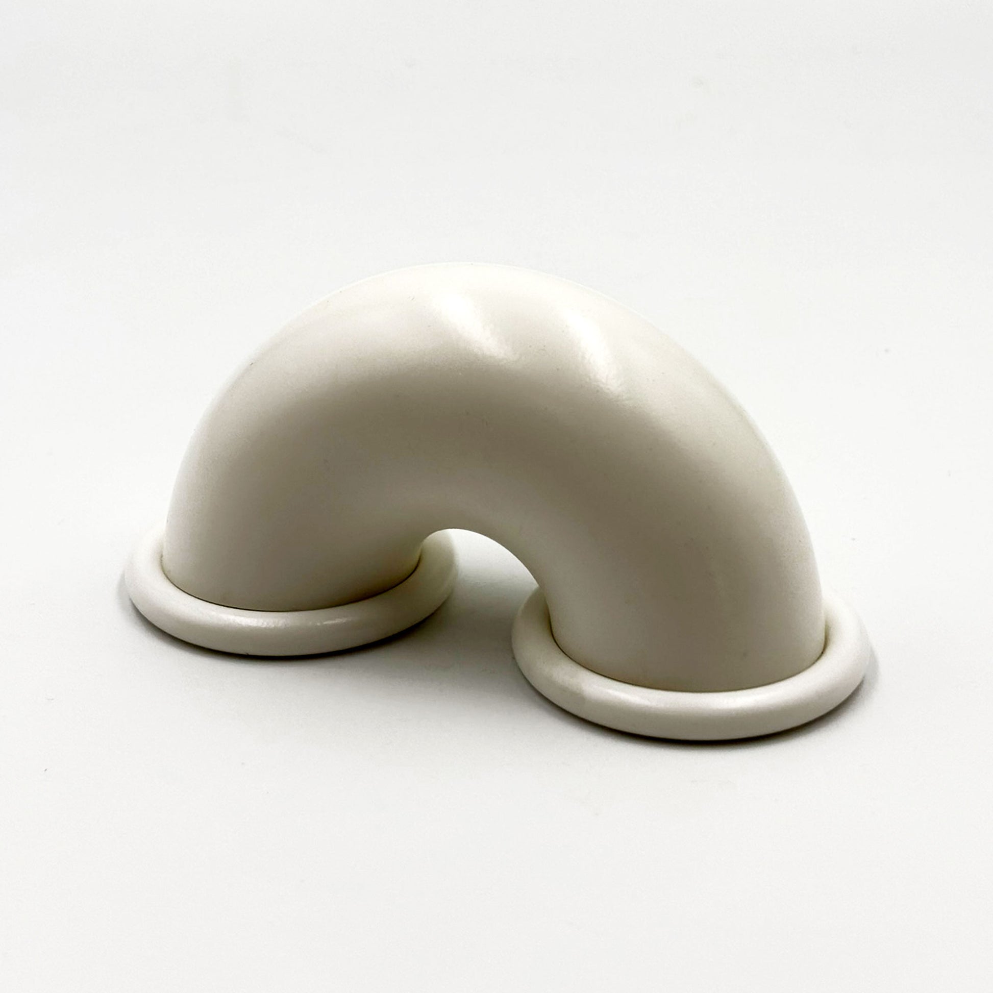 White colored macaroni-shaped handles on a white background