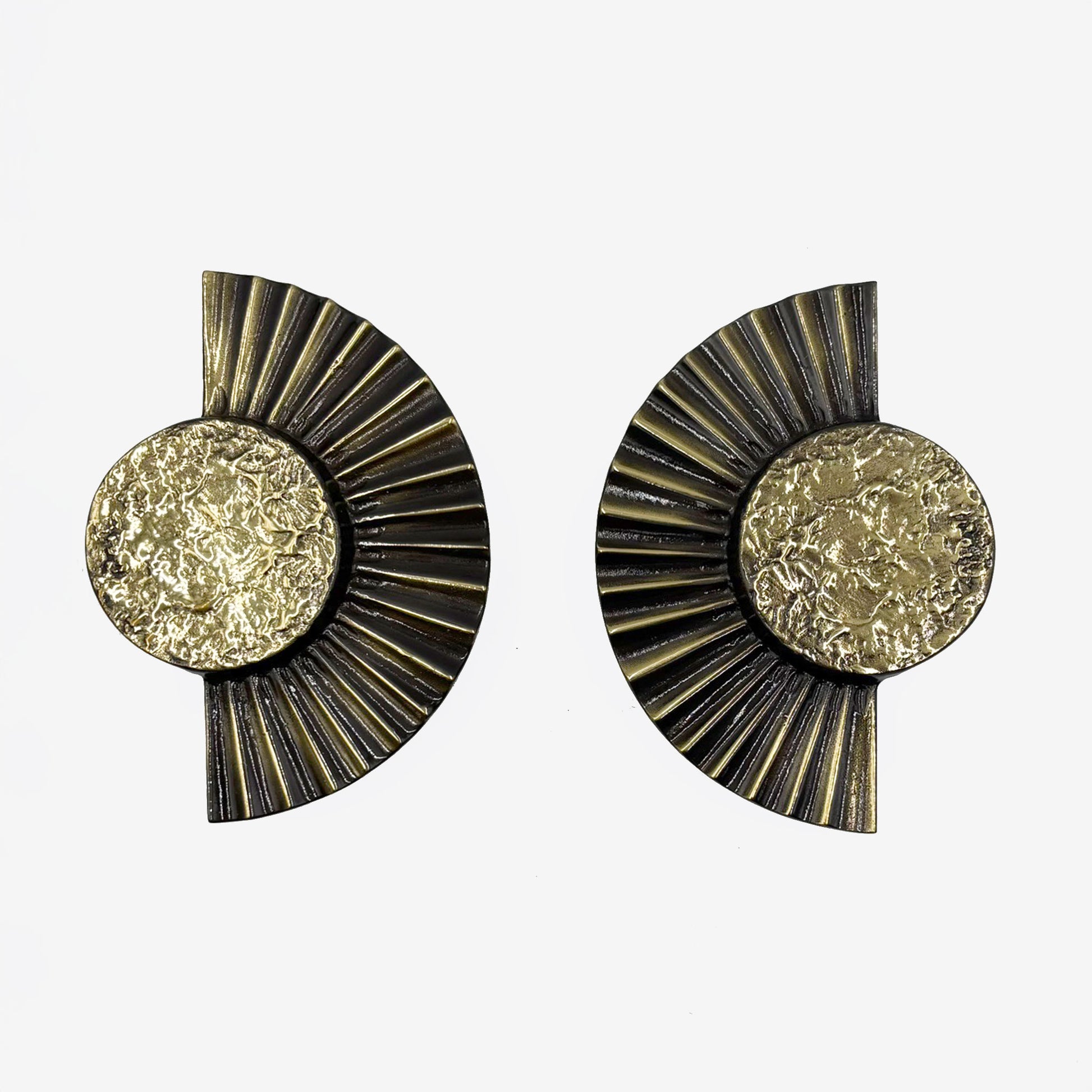 A pair of brass cabinet pull handles designed with a sun motif, featuring a circular design with rayed edges-on a white background.