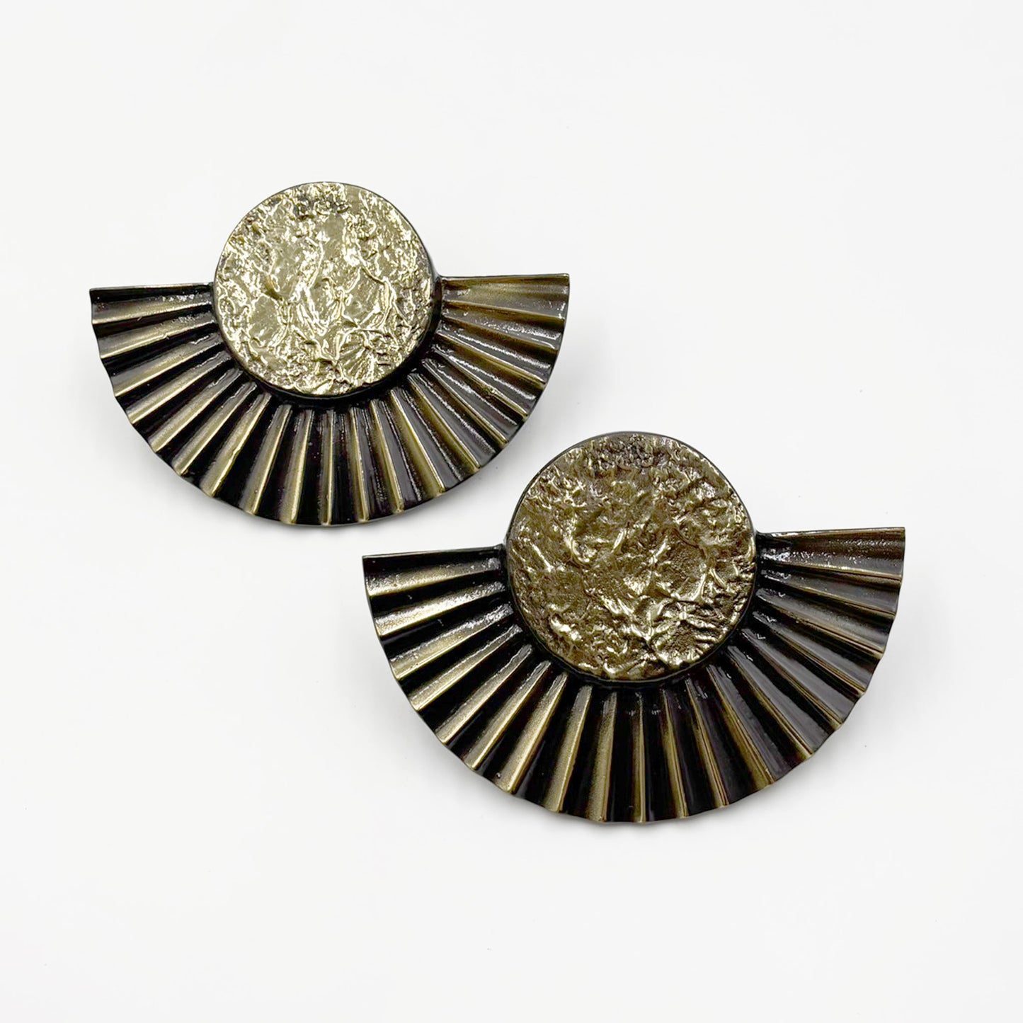 A pair of brass cabinet pull handles designed with a sun motif, featuring a circular design with rayed edges-on a white background.