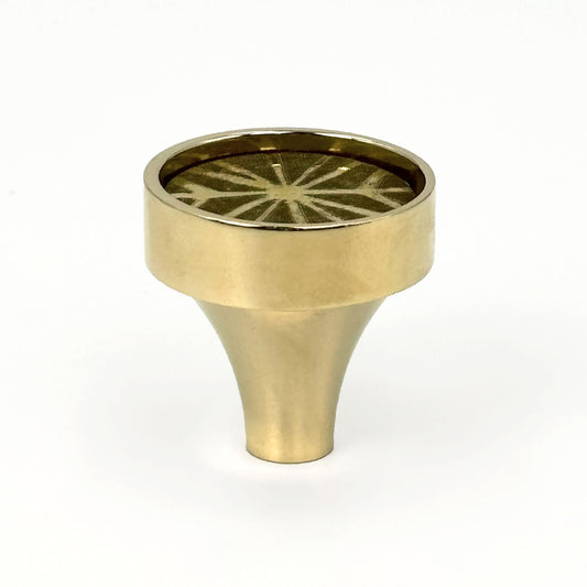 Patterned Aurora round cabinet pull with etched lines on a white background