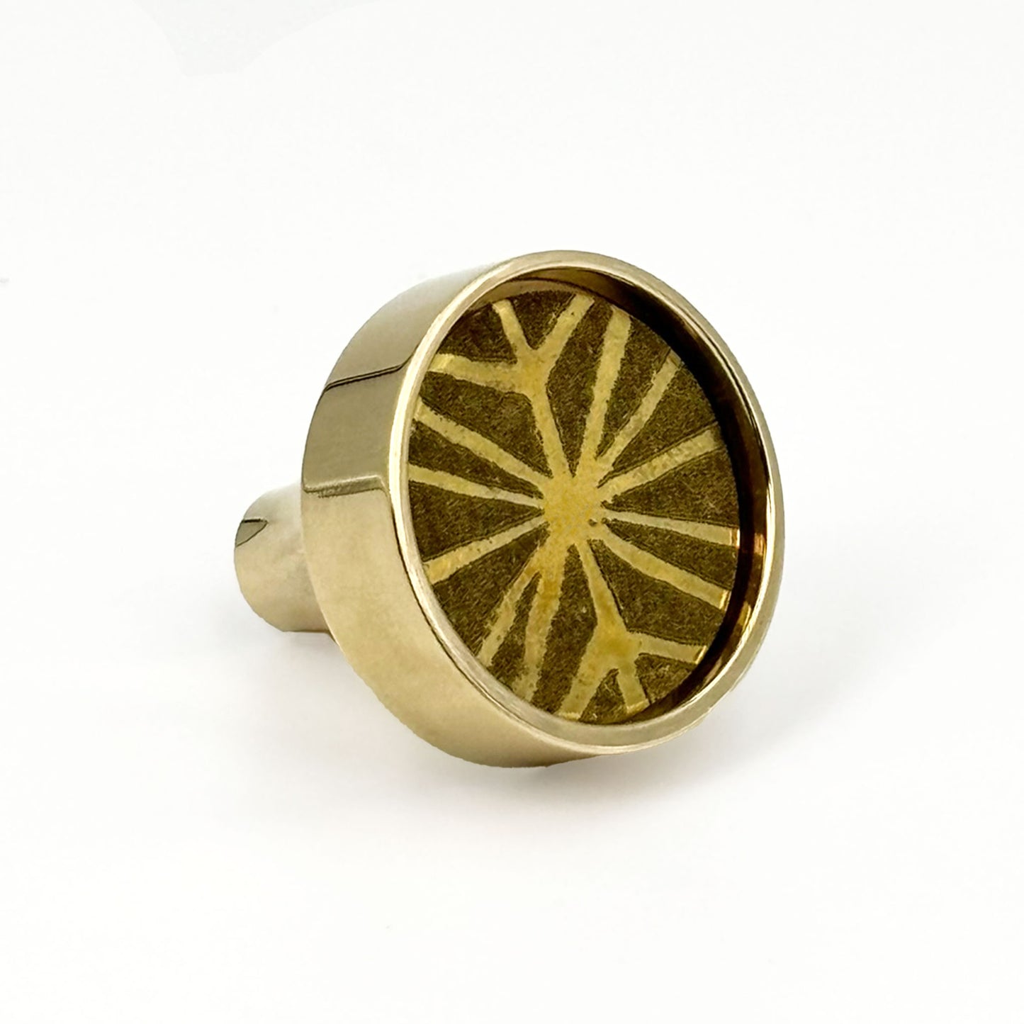 Patterned Aurora round cabinet pull on it side on a white background