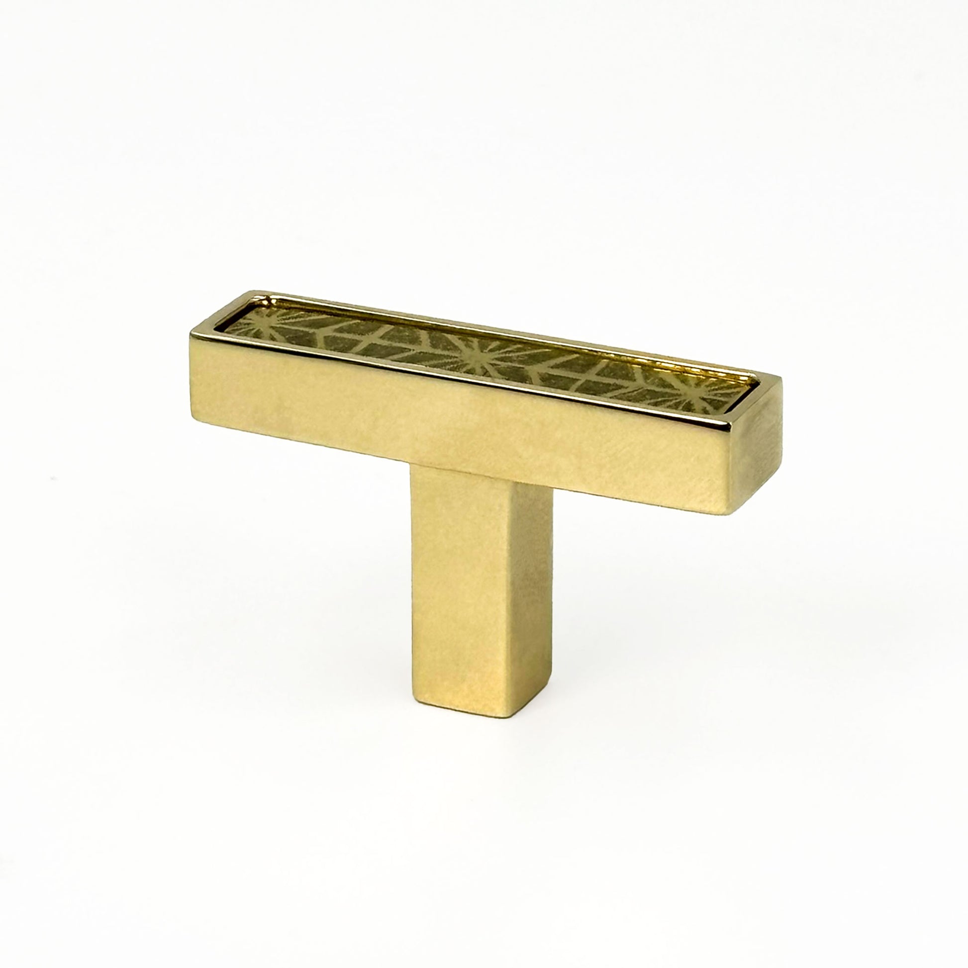 Unlacquered Brass cabinet T-[ull handle with geometric design on a white background