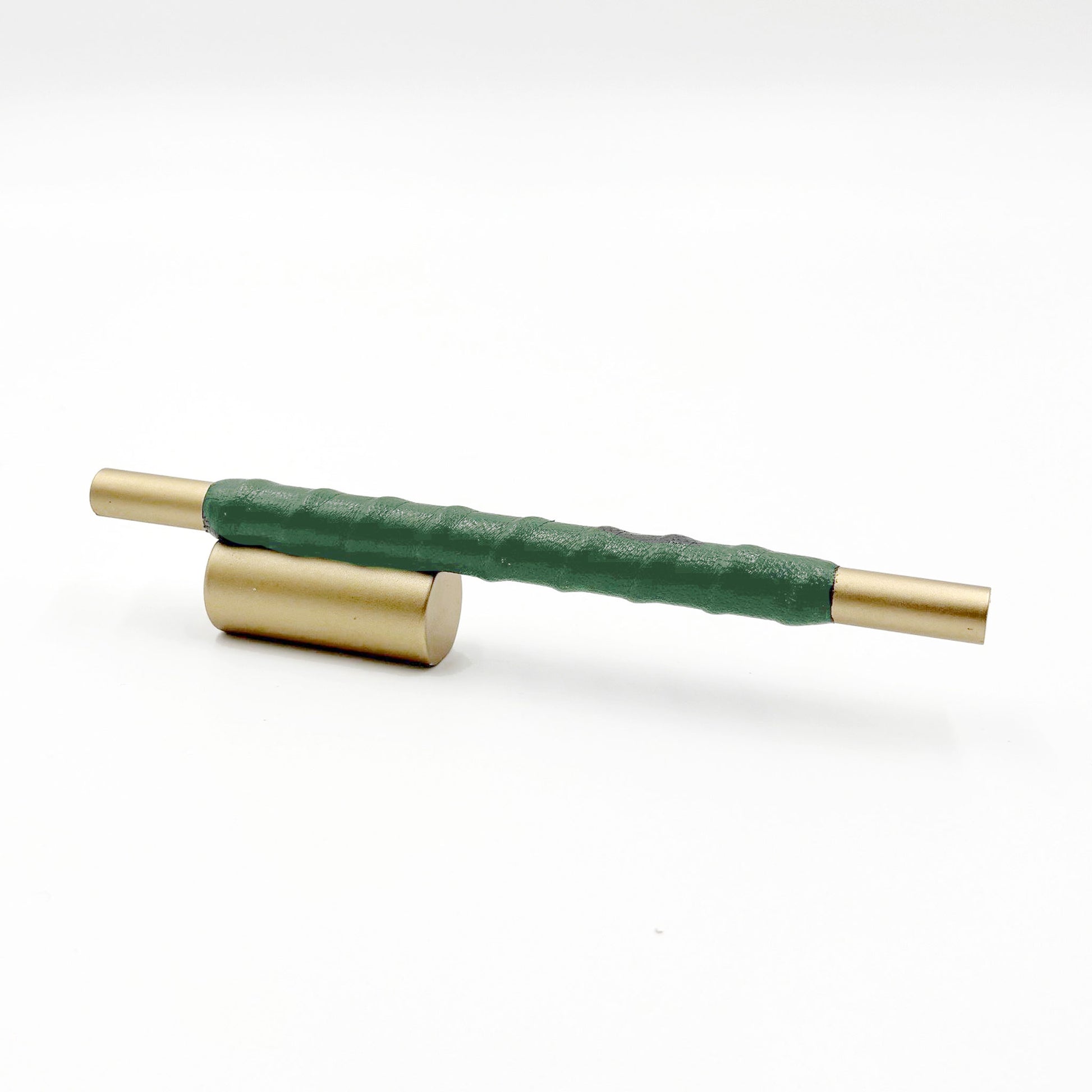 Satin Brass cylindrical cabinet pull with kelly green leather wraped handle on a white background