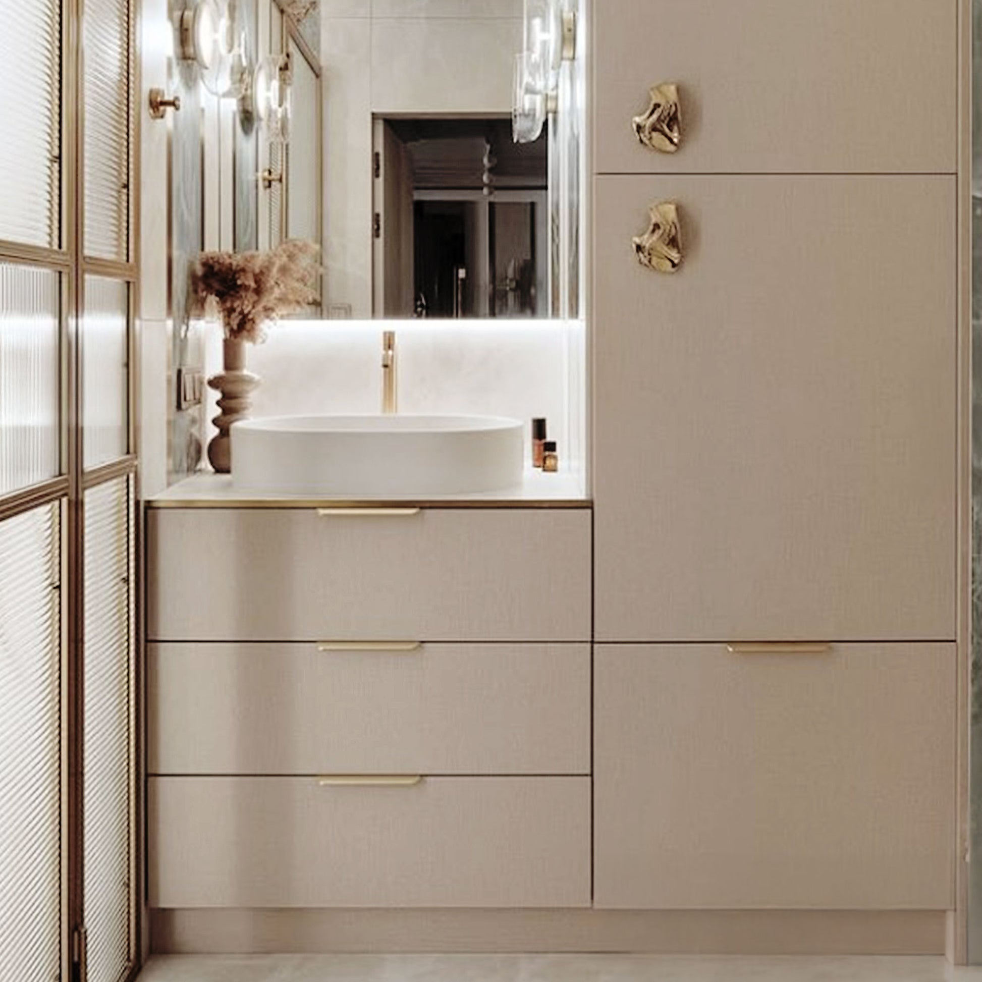 Modern brass tab pulls installed on a beige cabinet