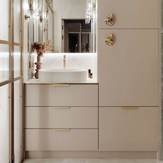 Modern brass tab pulls installed on a beige cabinet