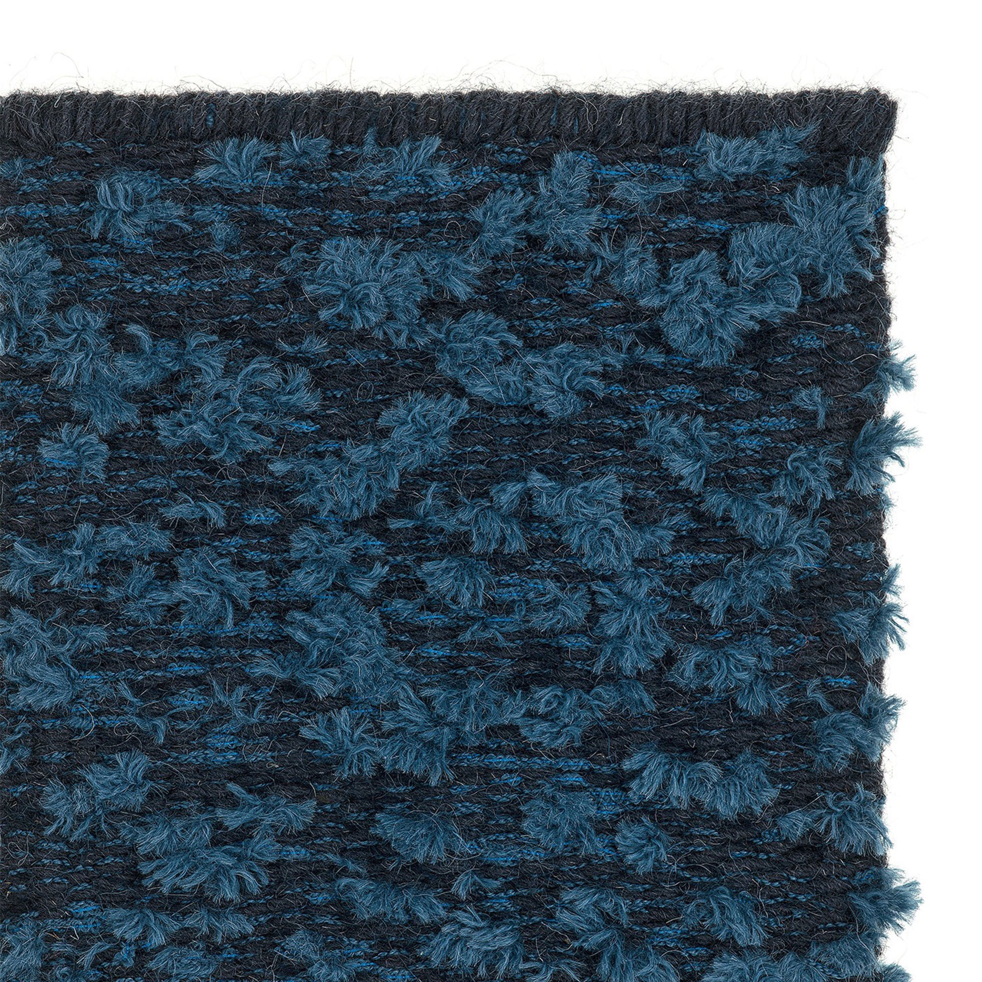 Cardu rug style in midnight blue and medium blue colored tufted flat weave