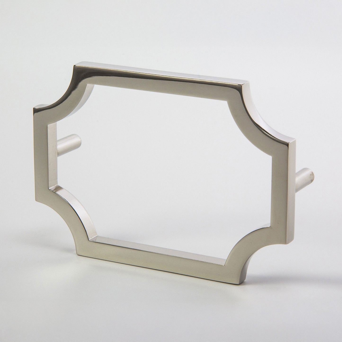 A nickel-finished metal hardware pull with a decorative quatrefoil-style frame and flat side pegs, shown on a light gray background.