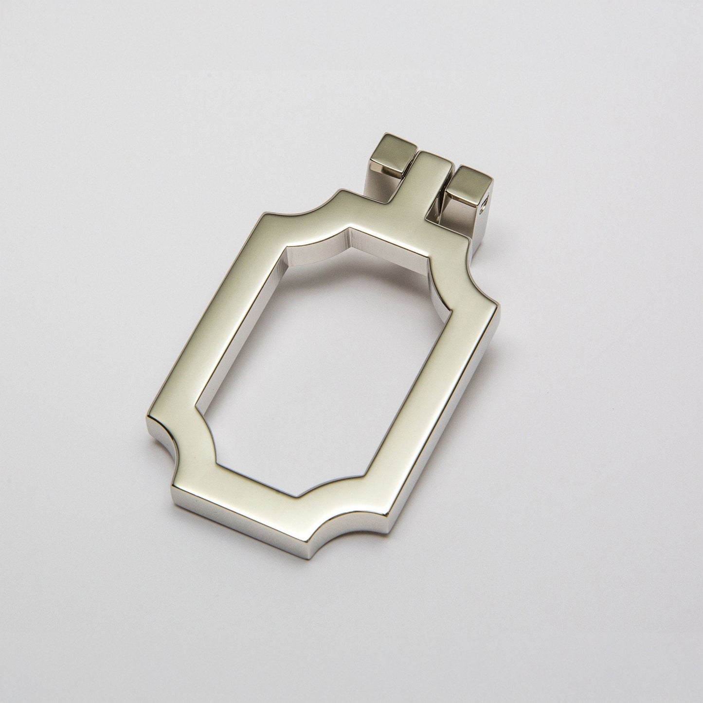 A small curved corners cabinet pull finished in a polished nickel, shown on a clean light gray background.