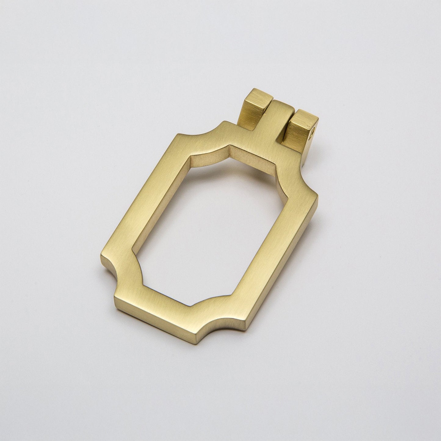 A cabinet pull finished in a satin brass with curved corners, shown on a clean light gray background.