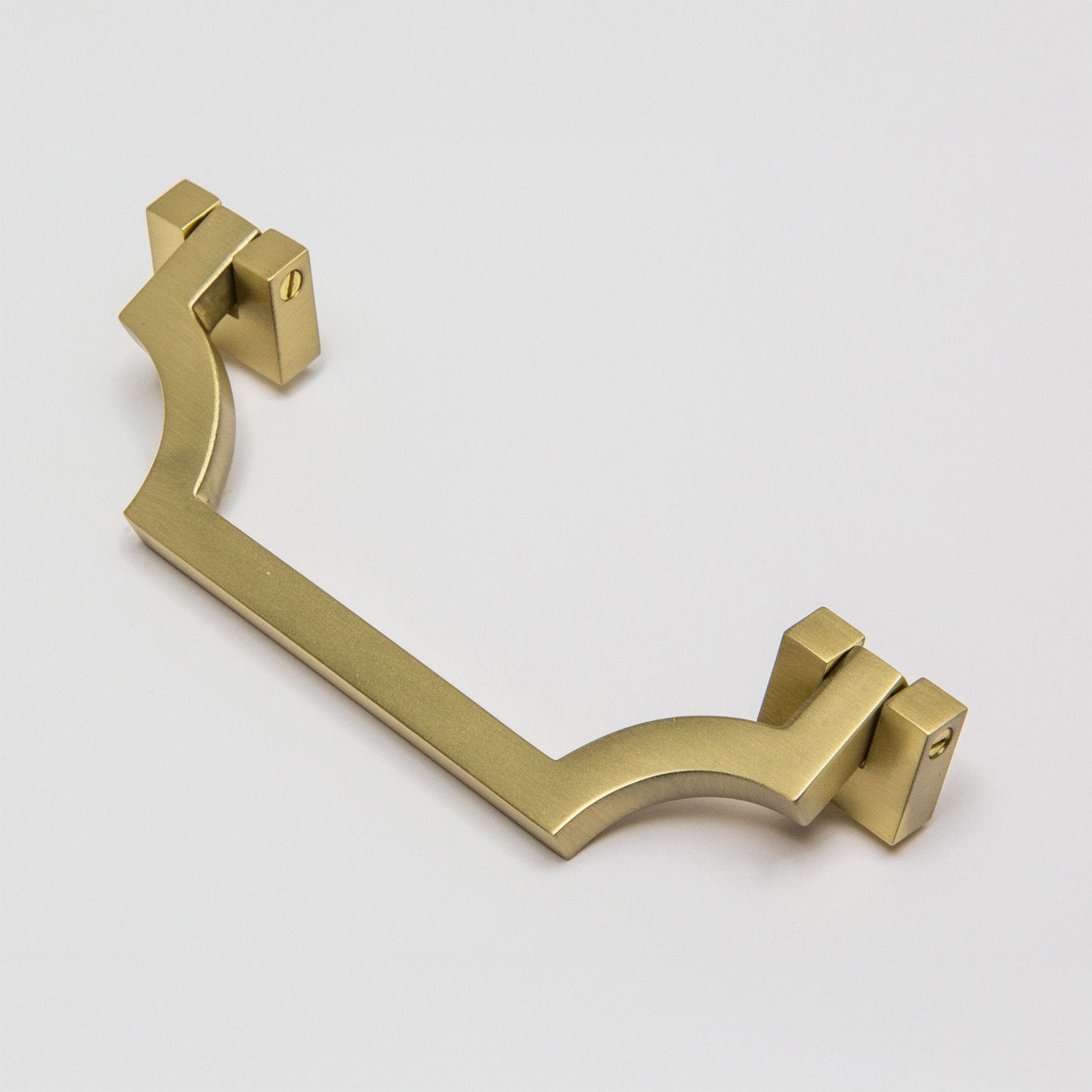 A modern curved bar handle drop pull in a brushed satin brass finish, shown on a light gray background.