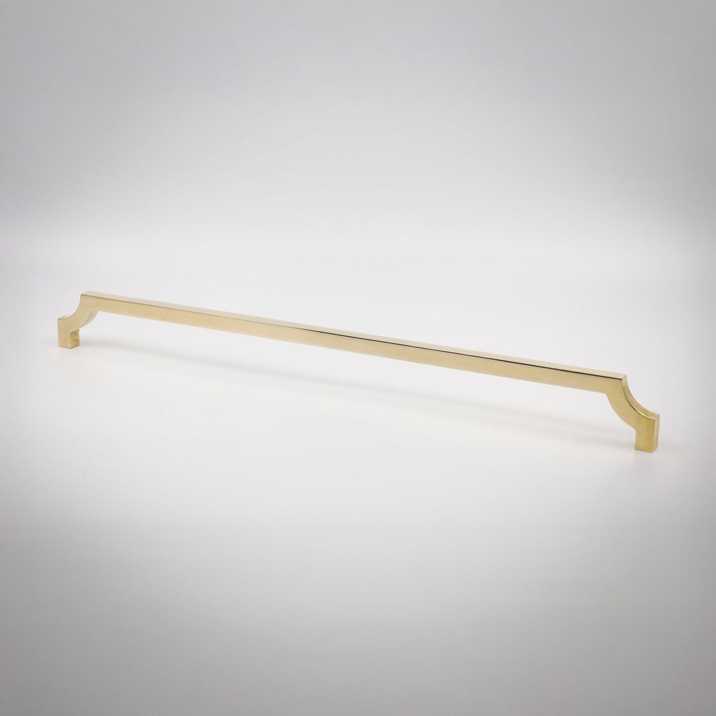 A long, slender cabinet pull in a polished unlaquered brass finish shown against a neutral background.